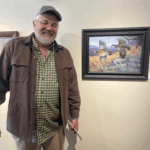 Duane Hada stands beside a framed quail painting displayed on an Artefex 6 mm all-in-panel at Rivertown Gallery